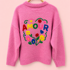 Back of pink knitted jumper with large colourful AMOUR floral and heart embroidery.