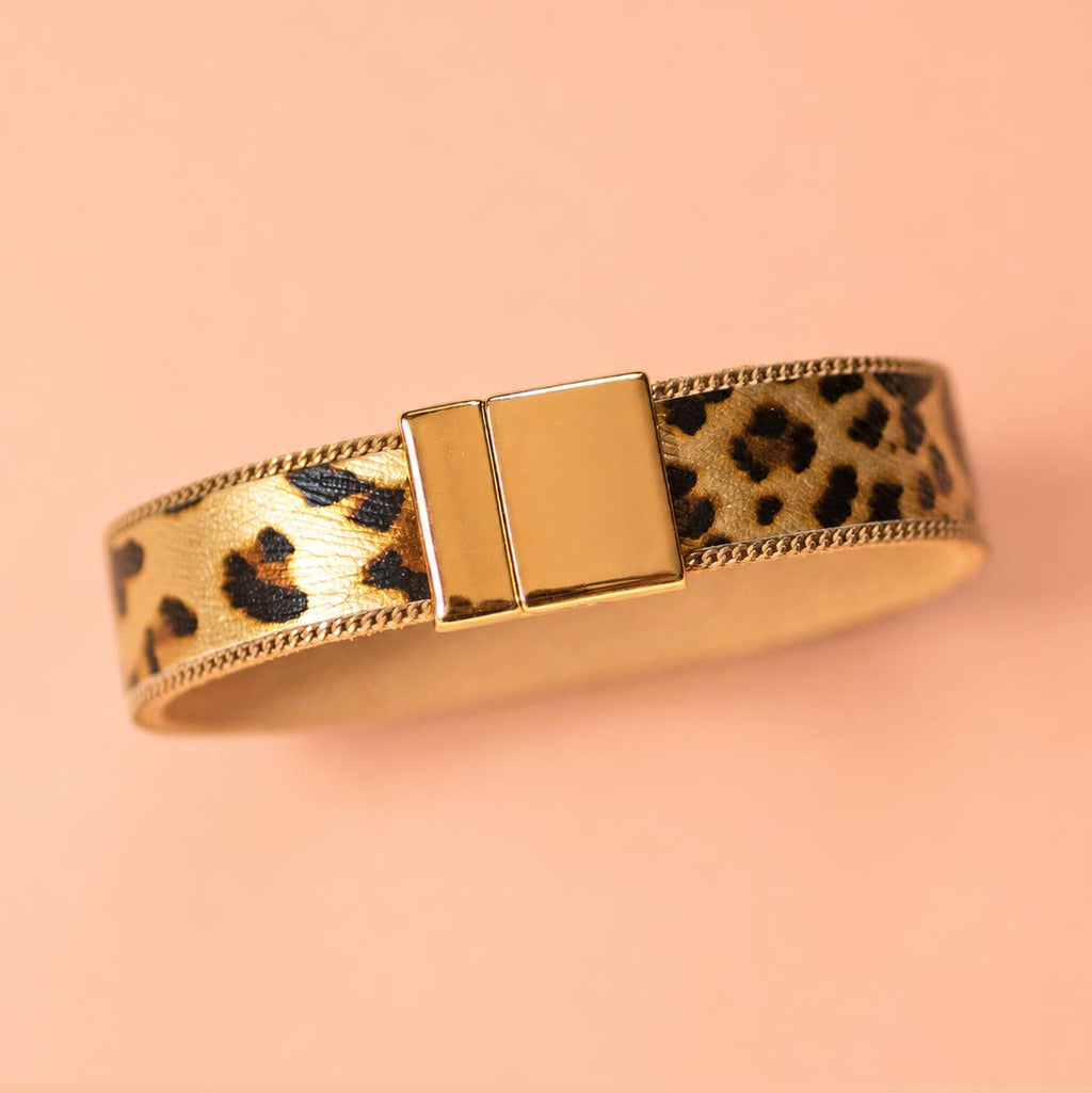 Leopard print bracelet with polished gold tone edging and rectangular magnetic clasp.