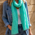 Fresh aqua green bird print scarf bringing a gorgeous splash of colour to a relaxed denim look.