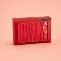 Red Dirty Bitch novelty soap bar in matching red presentation box on a soft peach background.