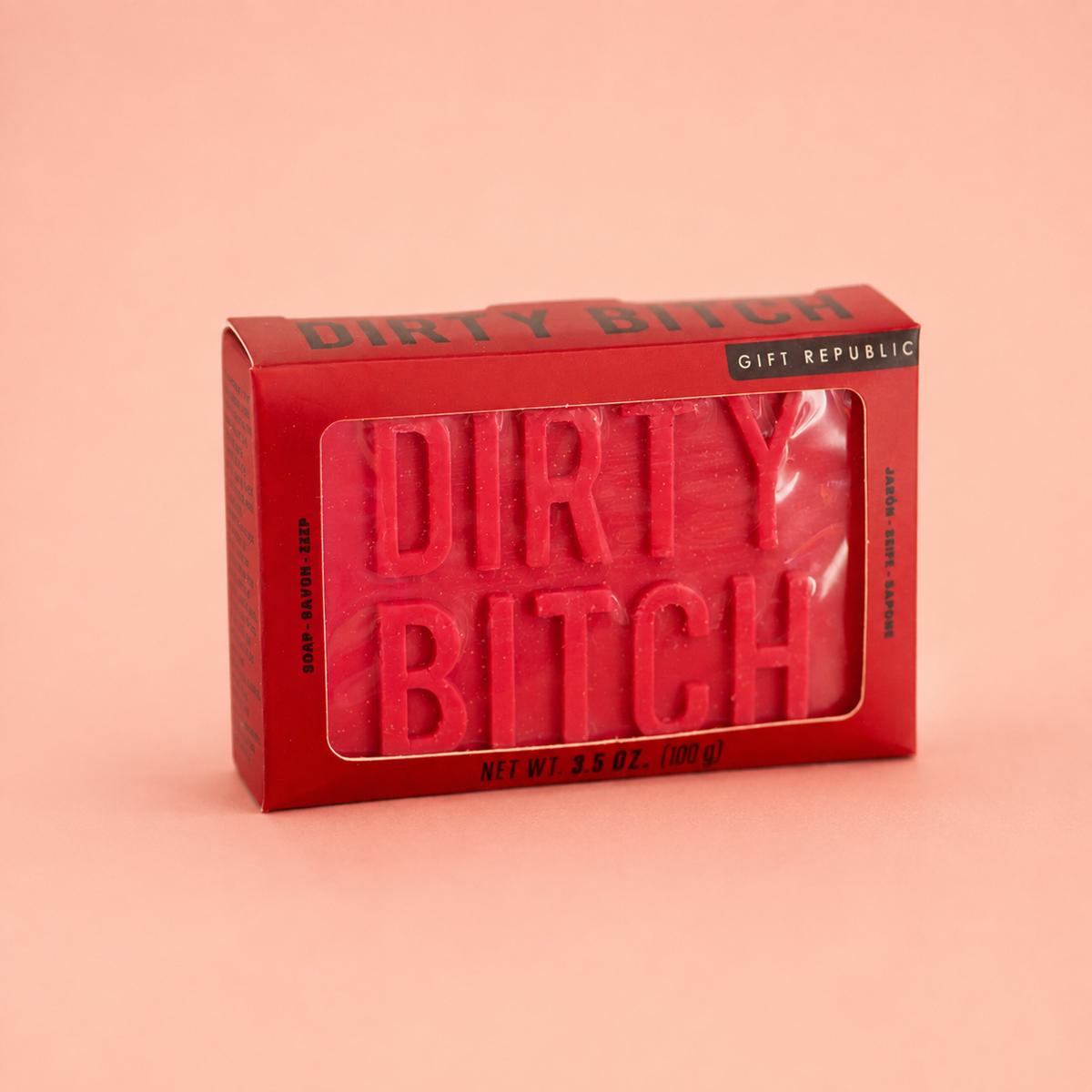Red Dirty Bitch novelty soap bar in matching red presentation box on a soft peach background.