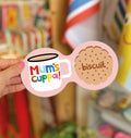 Pink Mum’s Cuppa double coaster with colourful mug illustration and biscuit design, held in a hand.
