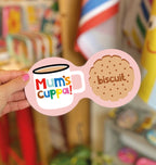 Pink Mum’s Cuppa double coaster with colourful mug illustration and biscuit design, held in a hand.
