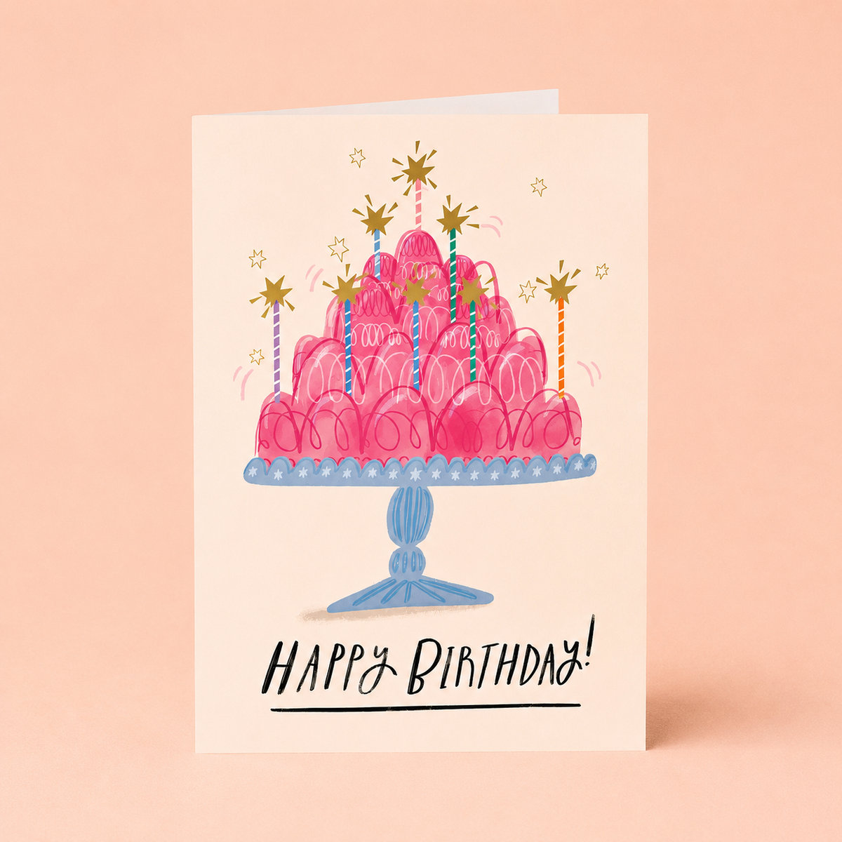 Colourful birthday card featuring a towering pink jelly with striped candles, golden stars and Happy Birthday message.