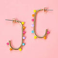 Gold tone open statement earrings decorated with pink, yellow, orange, turquoise and lilac dots.