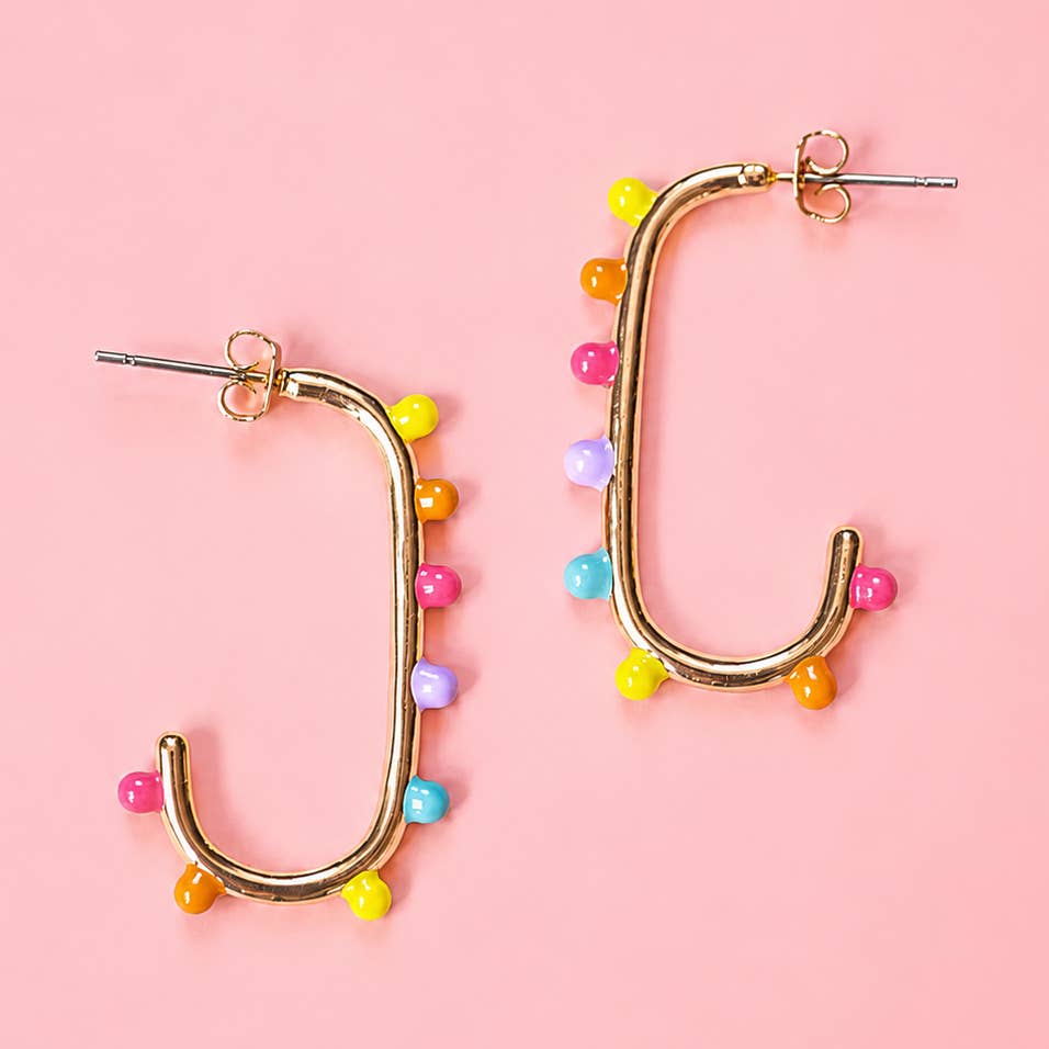 Gold tone open statement earrings decorated with pink, yellow, orange, turquoise and lilac dots.