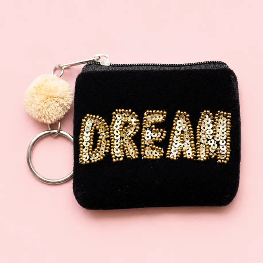 Black velvet mini keyring purse with gold beaded and sequin ‘DREAM’ lettering, cream pom pom and metal keyring.
