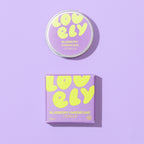 Blueberry Cheesecake Lip Balm 10g tin and purple gift box on a lilac background.