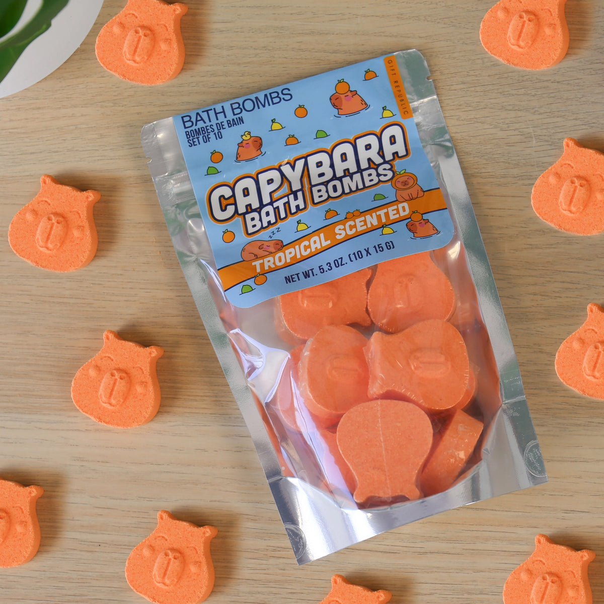 Capybara Bath Bombs pouch surrounded by orange capybara shaped mini bath bombs.
