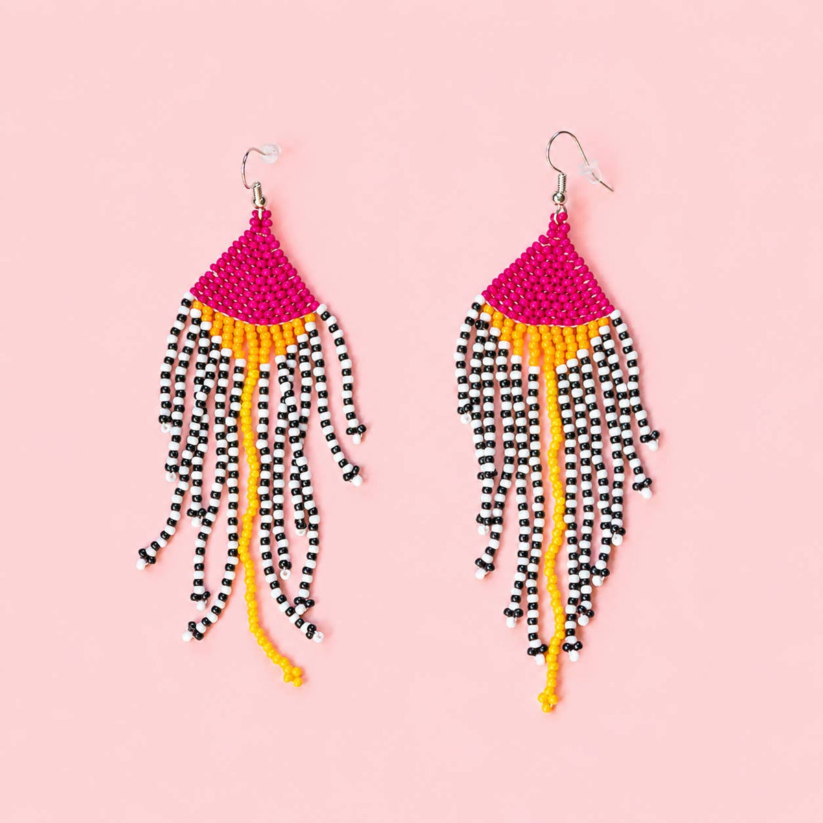 Pink and yellow beaded statement earrings with long black and white striped fringe.