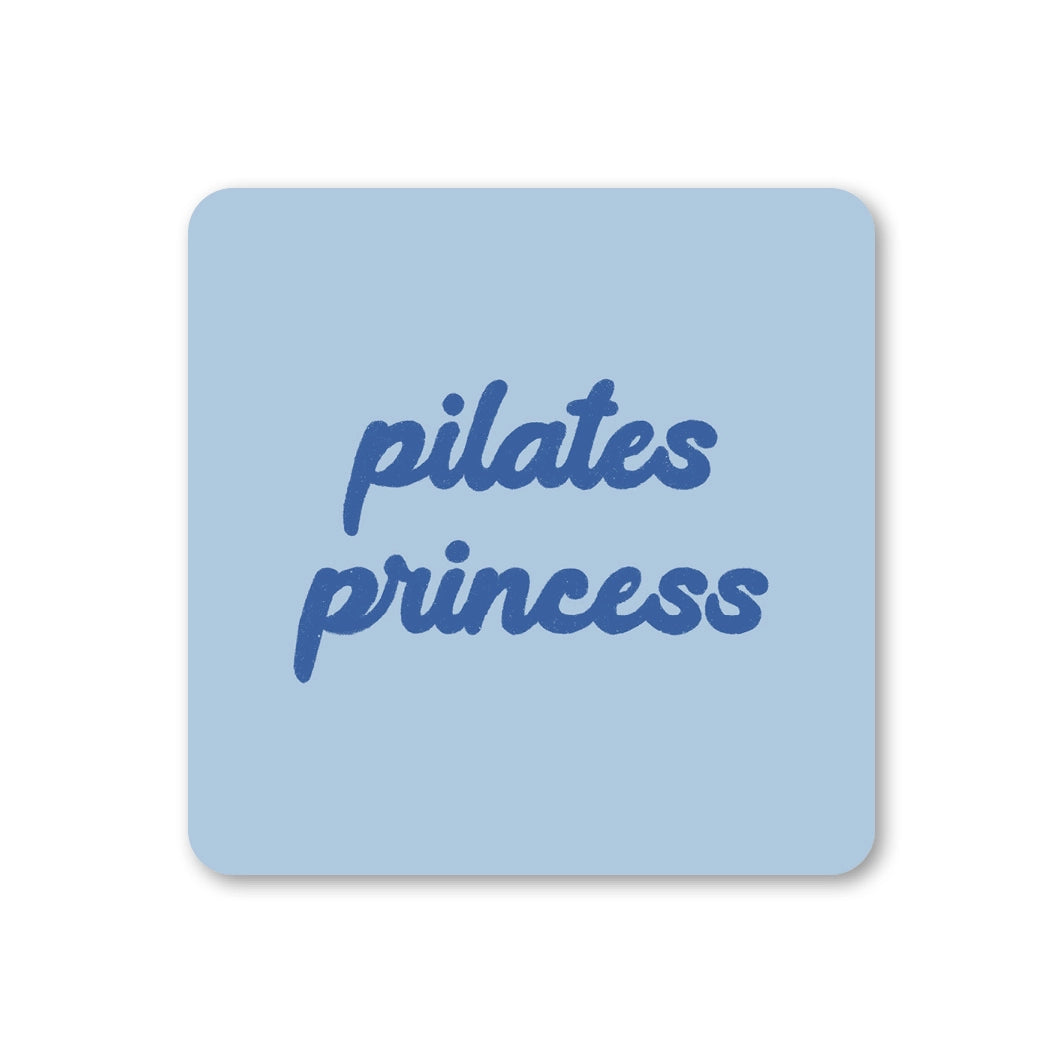 Pale blue square coaster with rounded corners and blue script reading Pilates Princess.