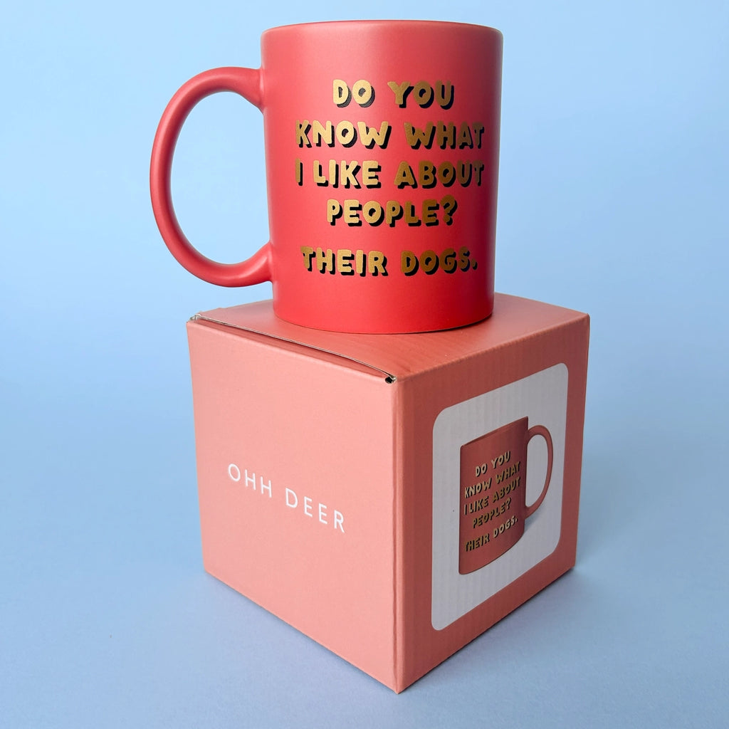 Pink dog lover slogan mug displayed on its matching pink gift box against a pale blue background.