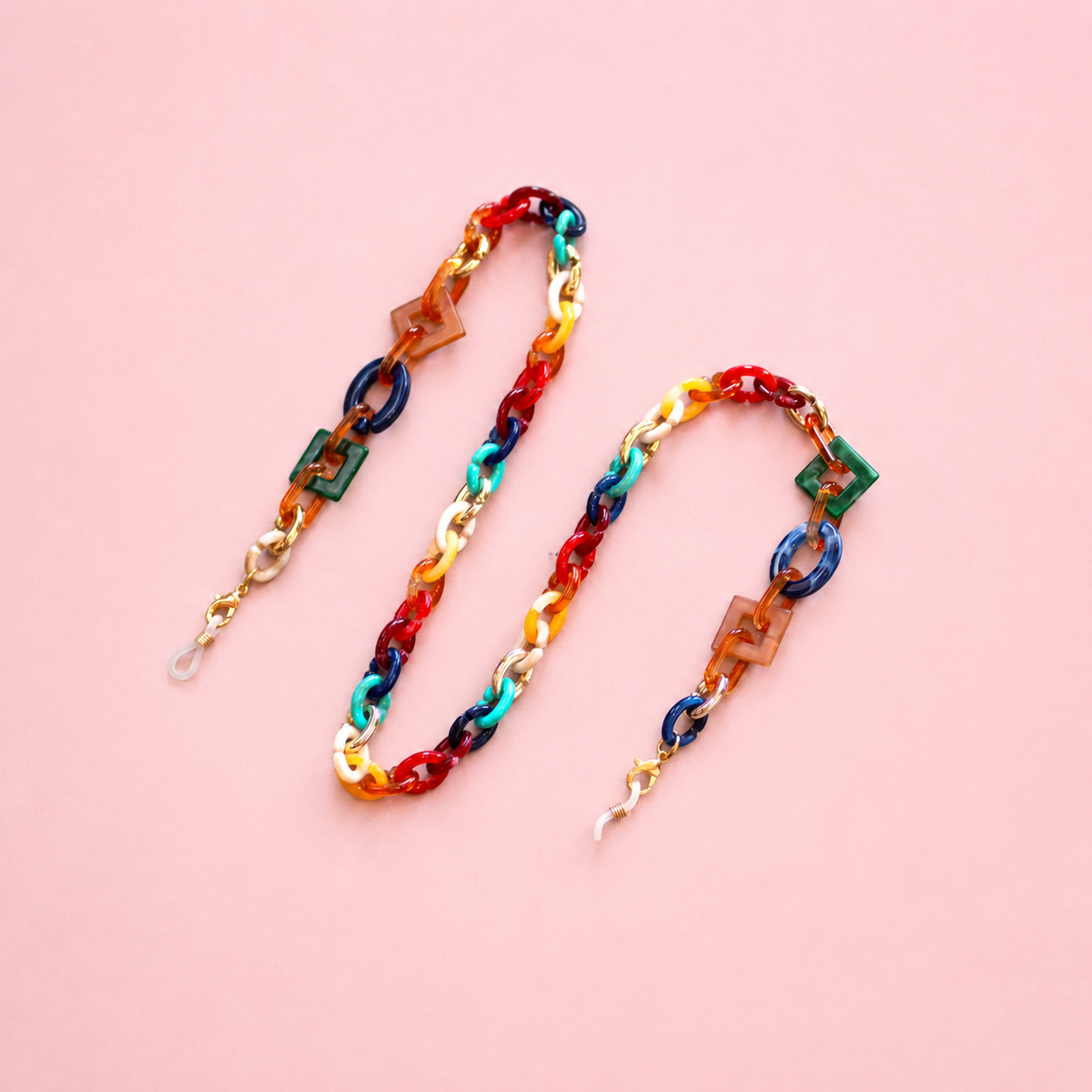 Multicolour chunky link glasses chain and necklace with red, blue, green, orange and gold tone links on a pale pink