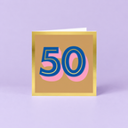 Colourful 50th birthday card with large blue number 50, pink shadow detail, warm gold background and metallic gold foil border.
