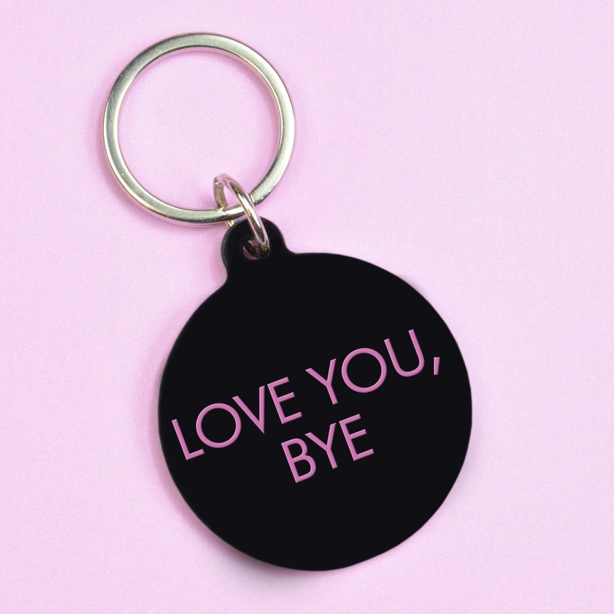 Black keychain with 'LOVE YOU, BYE' text on a pink background