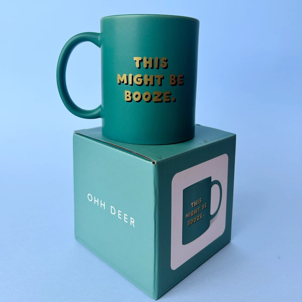 Green This Might Be Booze ceramic mug displayed on its matching green gift box against a pale blue background.