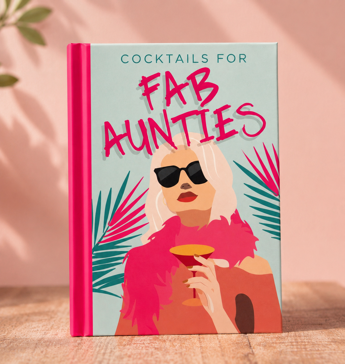 Cocktails for Fab Aunties colourful hardback cocktail recipe book with bright pink spine and illustrated cover.