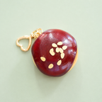 Chocolate doughnut bag charm keyring with glossy dark chocolate icing, almond style sprinkles and gold heart shaped clip.