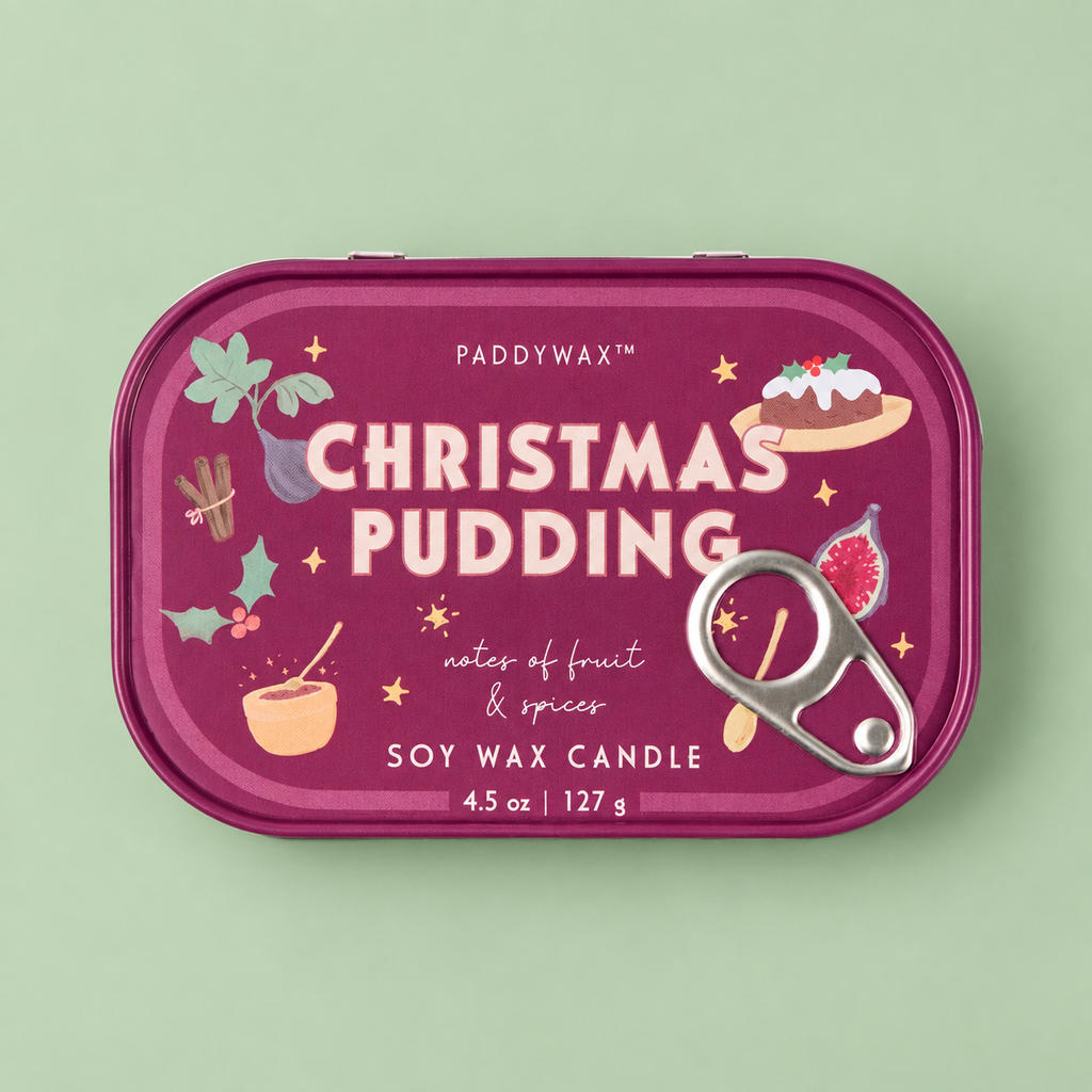 Berry pink Christmas Pudding soy wax candle tin with festive illustrations and silver pull ring on a pale green background.