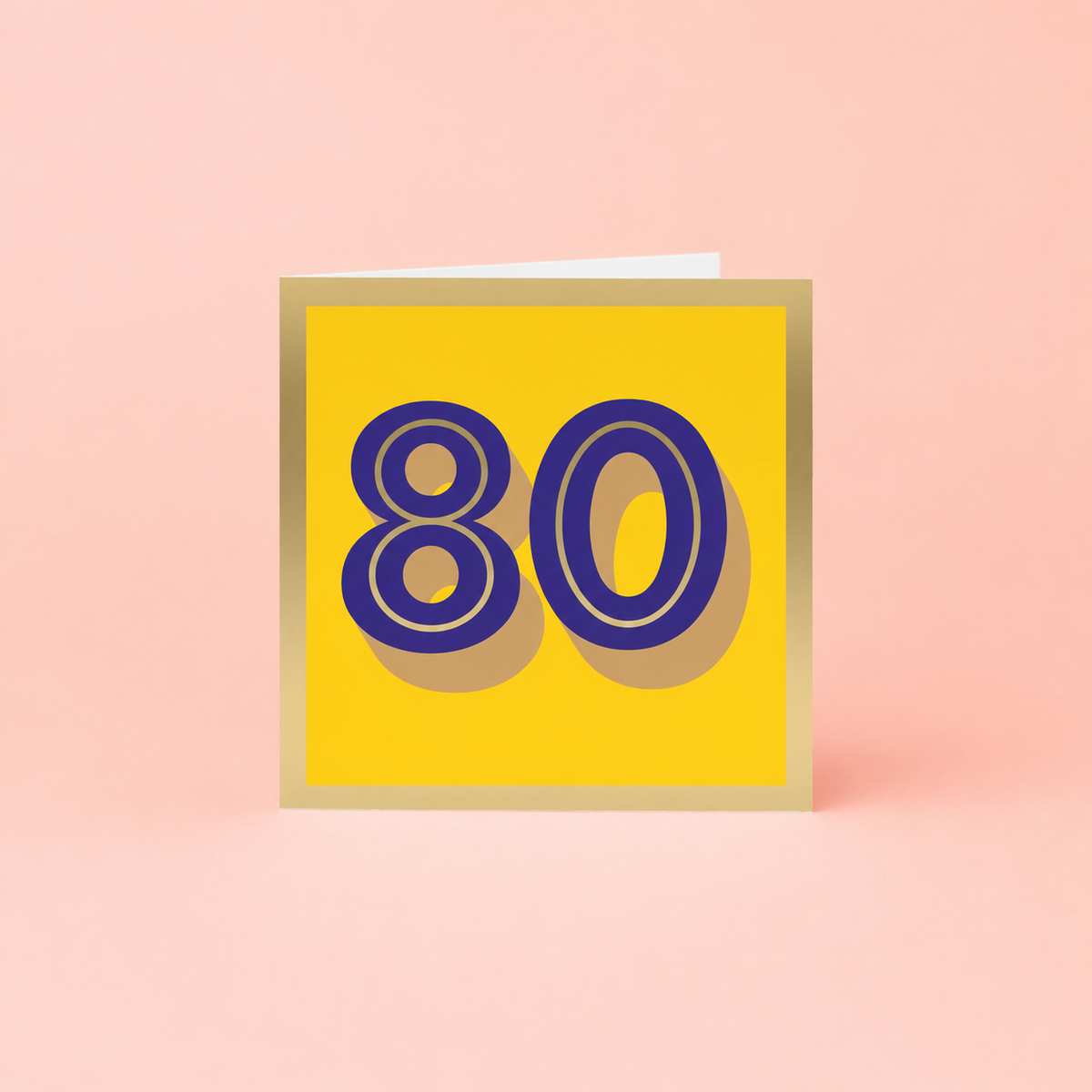 Colourful 80th birthday card with large purple number 80 on a bright yellow background with gold foil detailing and border.