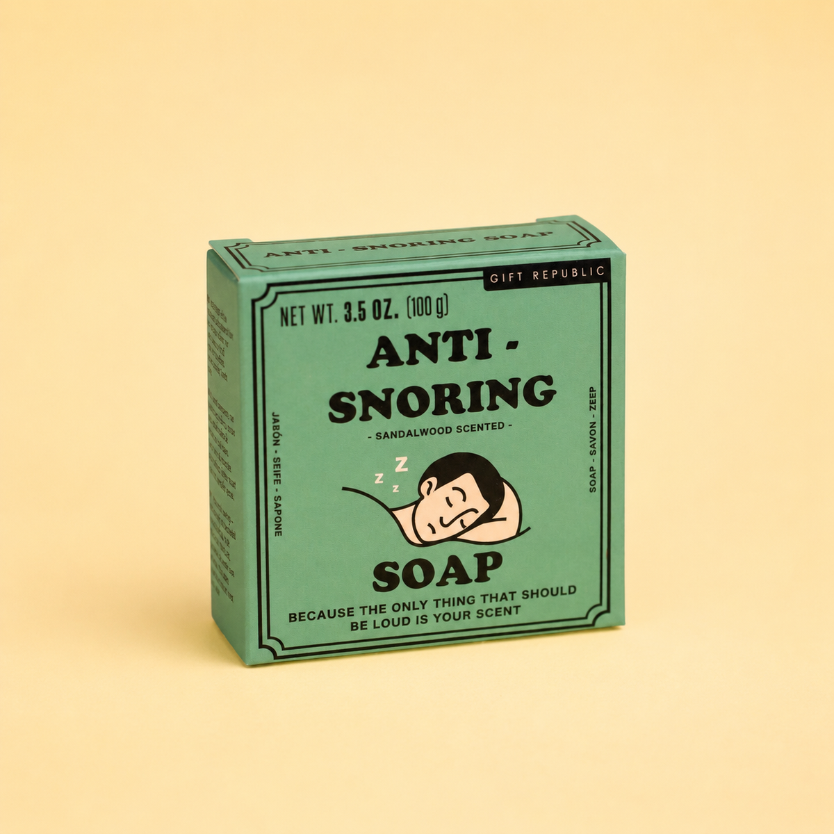 Box of 100g Anti Snoring sandalwood scented soap in green retro packaging with sleeping man illustration on a pale yellow background.