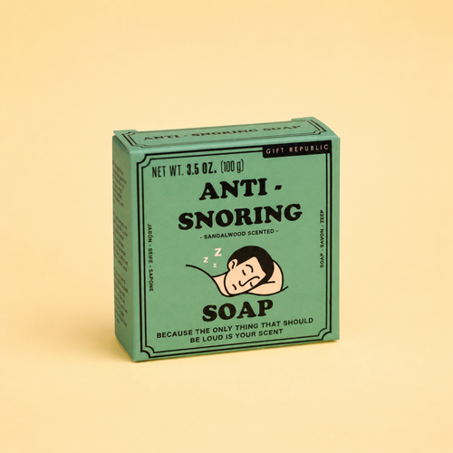 Box of 100g Anti Snoring sandalwood scented soap in green retro packaging with sleeping man illustration on a pale yellow background.