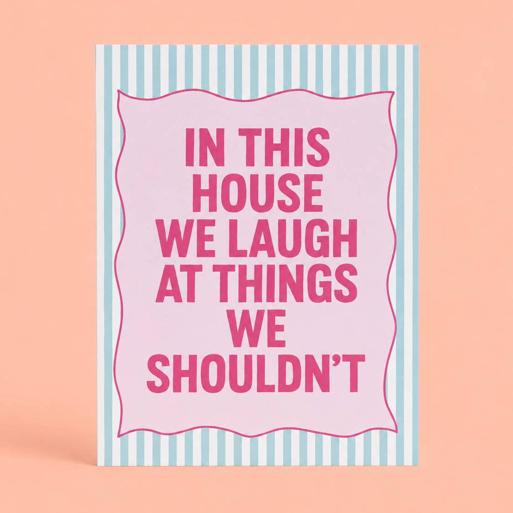Cheerful pink and mint A5 art print reading “In This House We Laugh At Things We Shouldn’t” with a playful striped border.