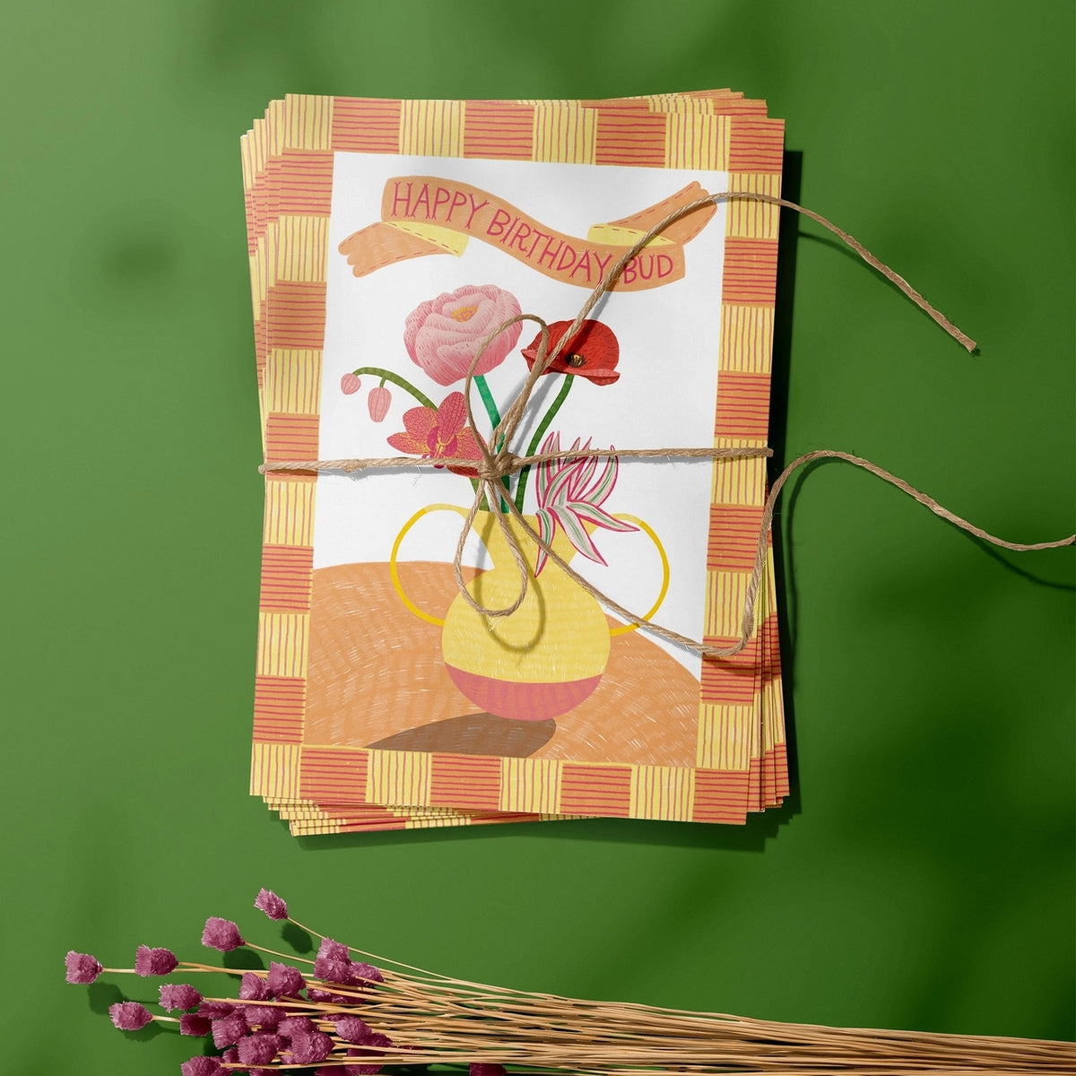 Colourful Happy Birthday Bud card featuring illustrated flowers in a yellow vase, styled with dried flowers on a green background.