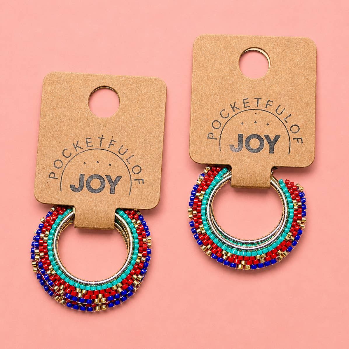 Red, turquoise, blue and gold beaded hoop earrings displayed on Pocketful of JOY jewellery cards.
