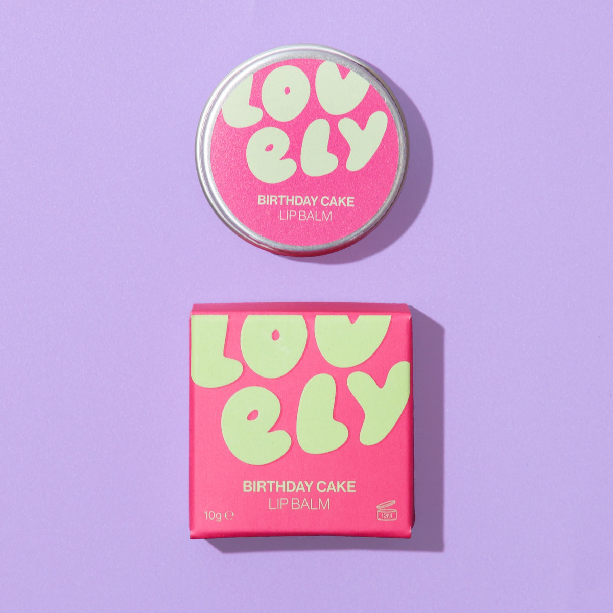 Birthday Cake Lip Balm 10g tin and bright pink gift box on a lilac background.