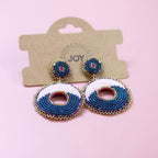 Pink and navy circular beaded statement earrings displayed on a Pocketful of JOY jewellery card.