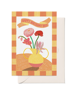 Happy Birthday Bud greeting card with pink and red flowers in a yellow vase and a colourful checked border.