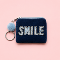 Navy mini coin purse keyring with sparkly silver and pale blue Smile lettering, blue pom pom and silver tone keyring