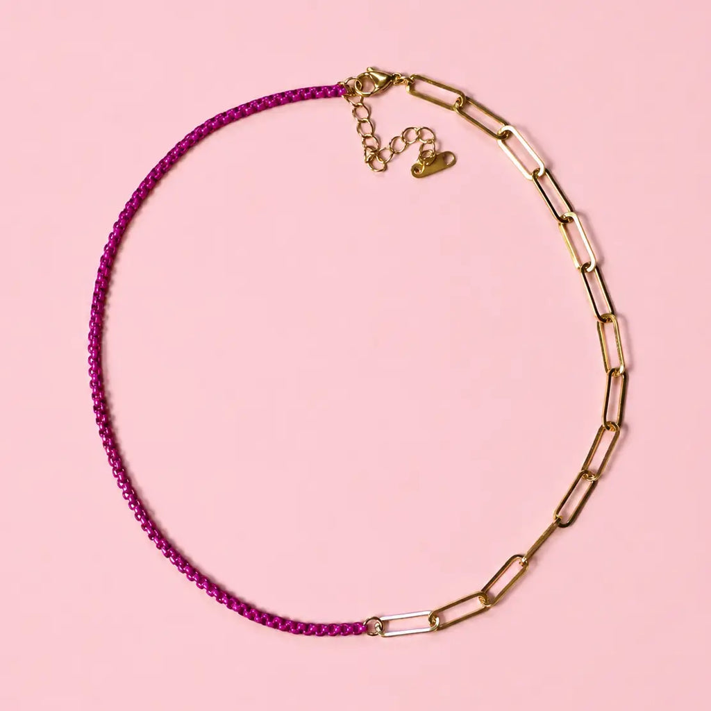 Two tone raspberry and gold plated stainless steel chain necklace on a soft pink background.