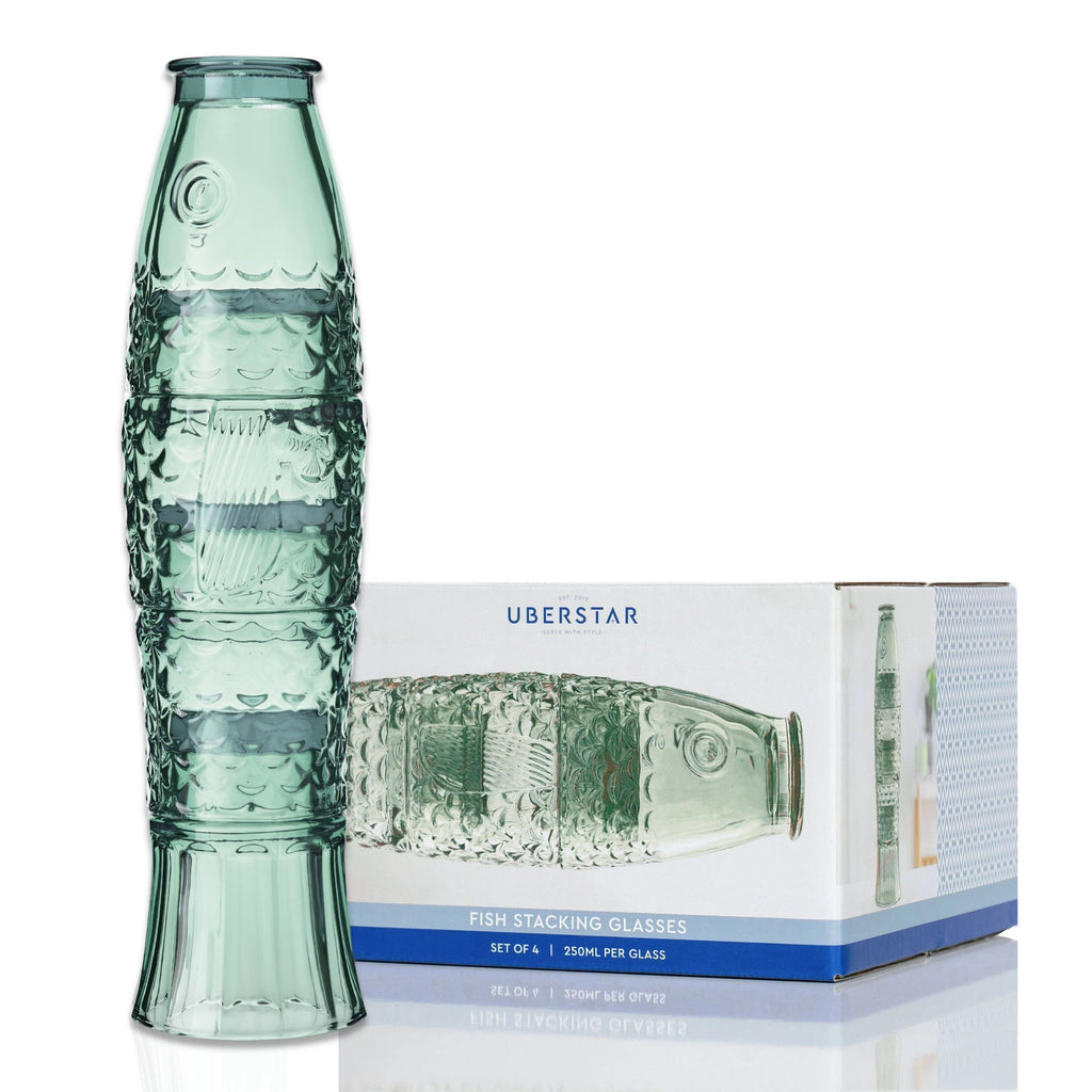 Green fish stacking glass set assembled beside its presentation box.