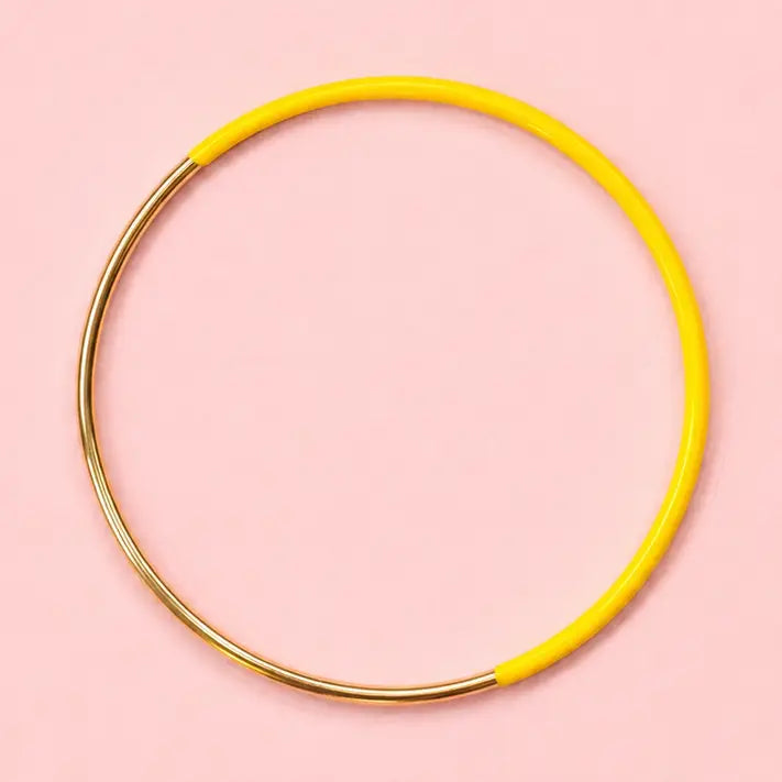 Yellow dip enamel stacking bangle with polished gold tone stainless steel detail.