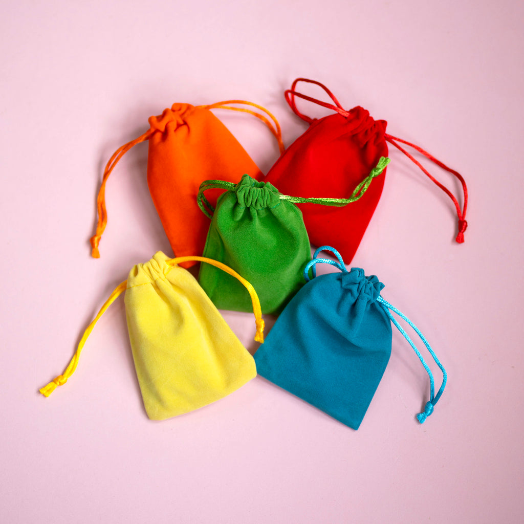 Colourful velvet drawstring mystery bags containing a surprise bracelet or bangle from Pocketful of Joy.