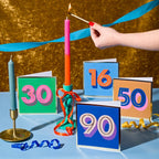 Colourful milestone birthday cards including a blue and orange 16th birthday card styled with candles and ribbons.

