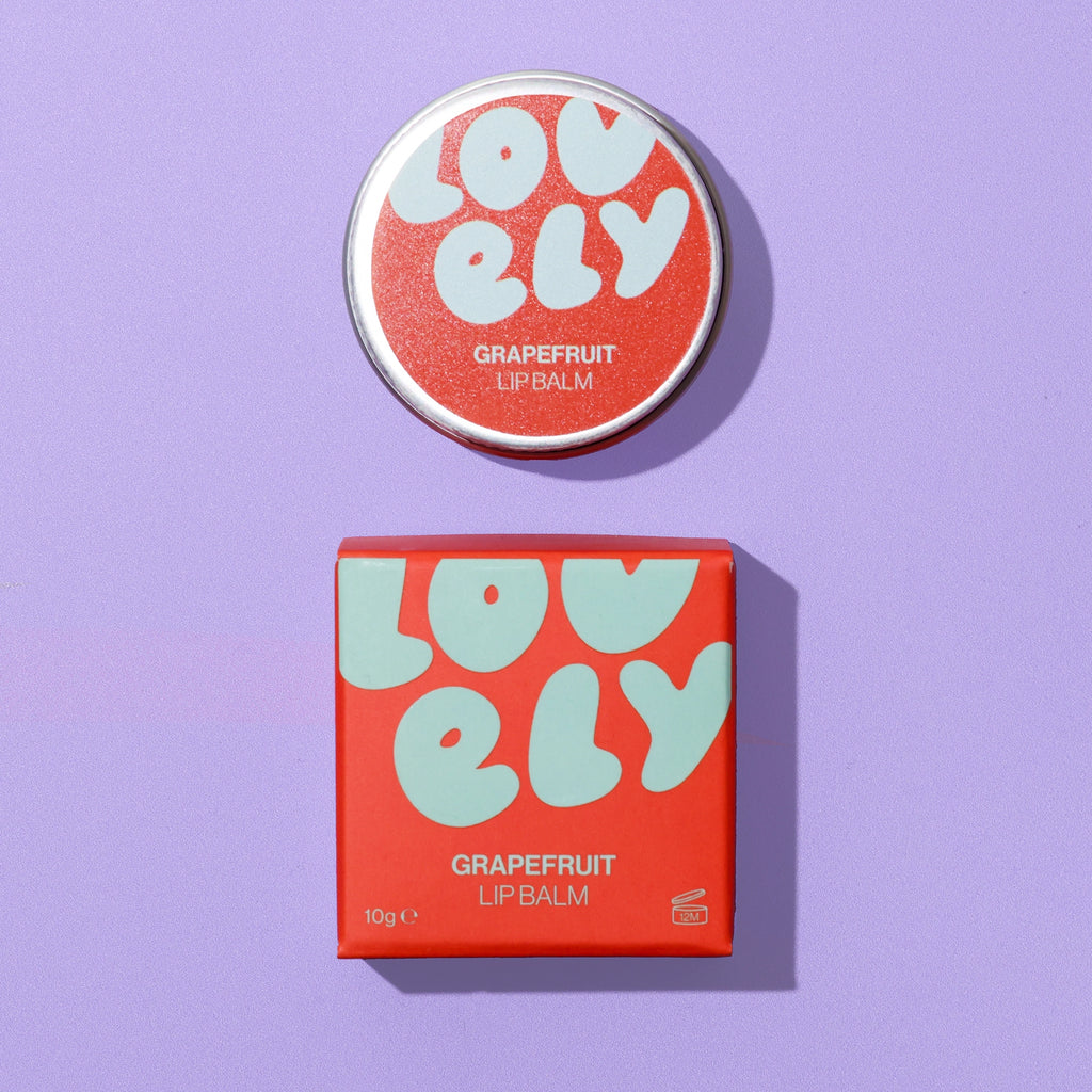 Grapefruit Lip Balm 10g tin and colourful orange and blue box on a lilac background.