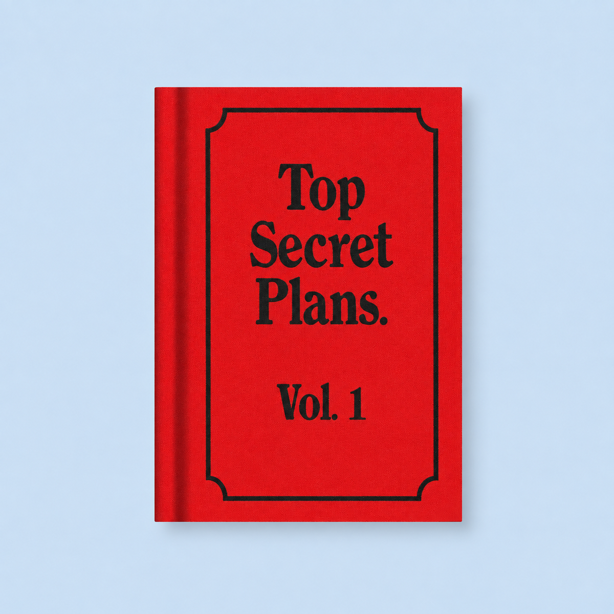 Bright red A7 fabric hardback notebook with black Top Secret Plans Vol. 1 text on a pale blue background.