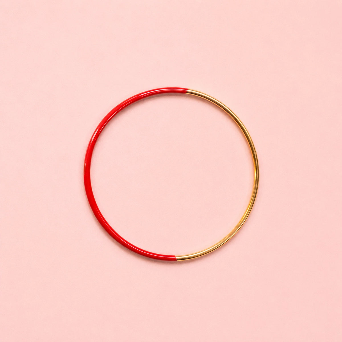 Red dip enamel stacking bangle with polished gold tone stainless steel detail.