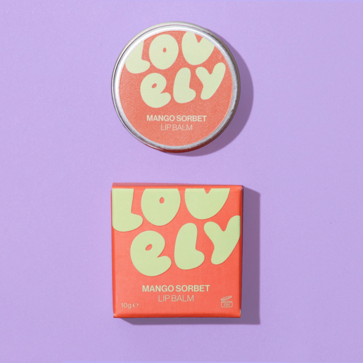 Mango Sorbet Lip Balm tin and orange box displayed against a lilac grid background.