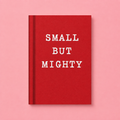 Bright red A7 fabric hardback notebook with white Small But Mighty lettering on a soft pink background.