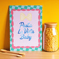 Joyful Pasta La Vista Baby A5 print with blue lettering, pink scallops and green gingham, styled beside a jar of pasta.