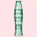 Four green glass tumblers stacked together to create a tall textured fish on a soft pink background.