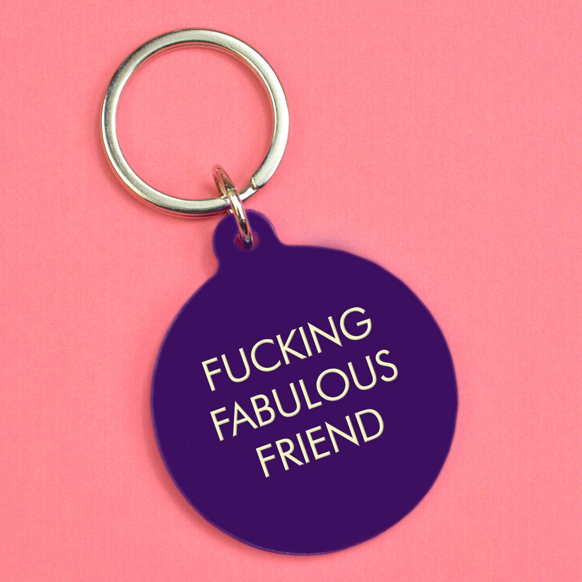 Deep purple round keyring with pale yellow Fucking Fabulous Friend lettering and silver-tone metal keyring attachment
