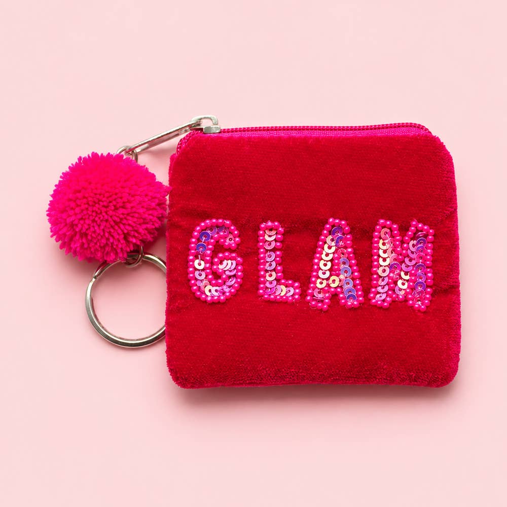 Bright pink velvet mini keyring purse with pink beaded and sequin ‘GLAM’ lettering, matching pom pom and silver tone keyring.