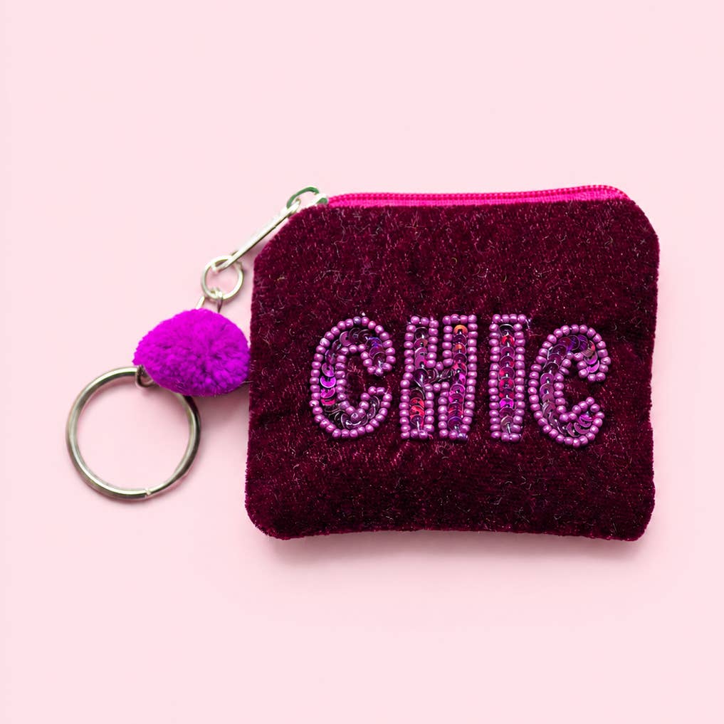 Purple velvet mini keyring purse with pink and purple beaded ‘CHIC’ lettering, purple pom pom and metal keyring.