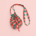 One of a kind coral, turquoise and blush crochet drawstring crossbody bag handmade by Corrine with a long strap