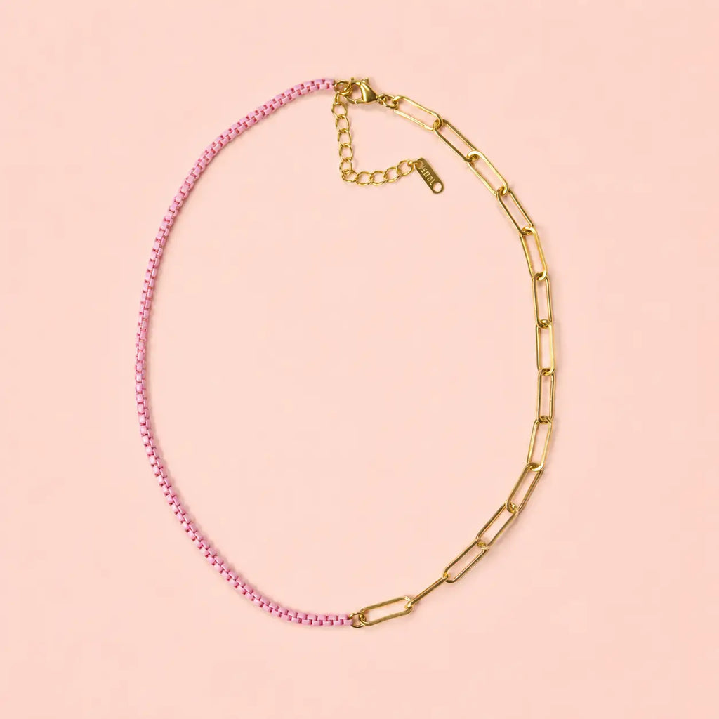 Two tone pale pink and gold plated stainless steel chain necklace on a soft peach pink background.